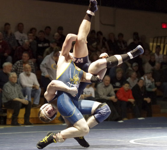Times Observer photo by Ben Oviatt Eisenhower's Alex Barnett flips Warren's Nick DeSimone during 160-pound action Friday.